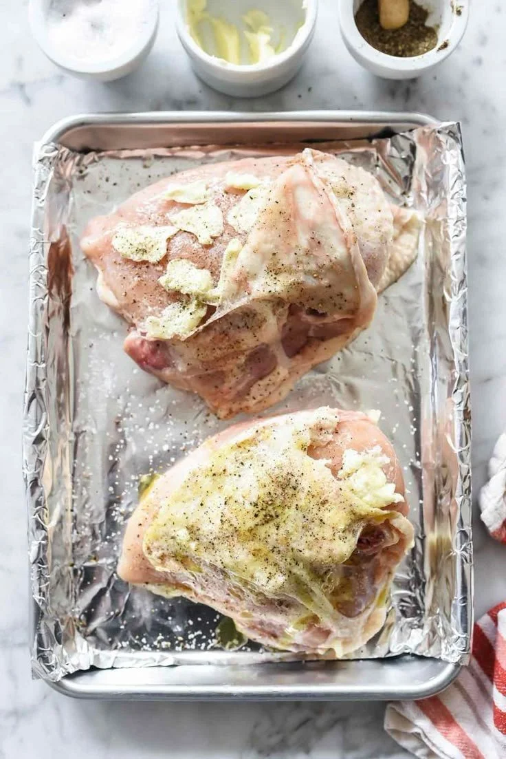 Juicy baked chicken breast recipe served with herbs and spices